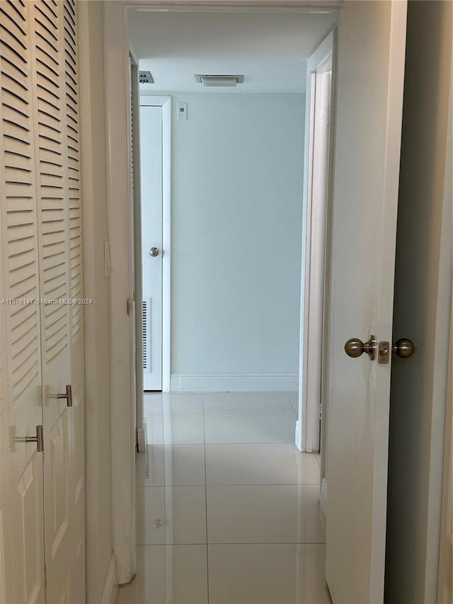 hall featuring light tile patterned floors