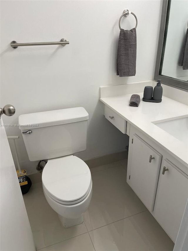 bathroom with tile patterned flooring, vanity, and toilet