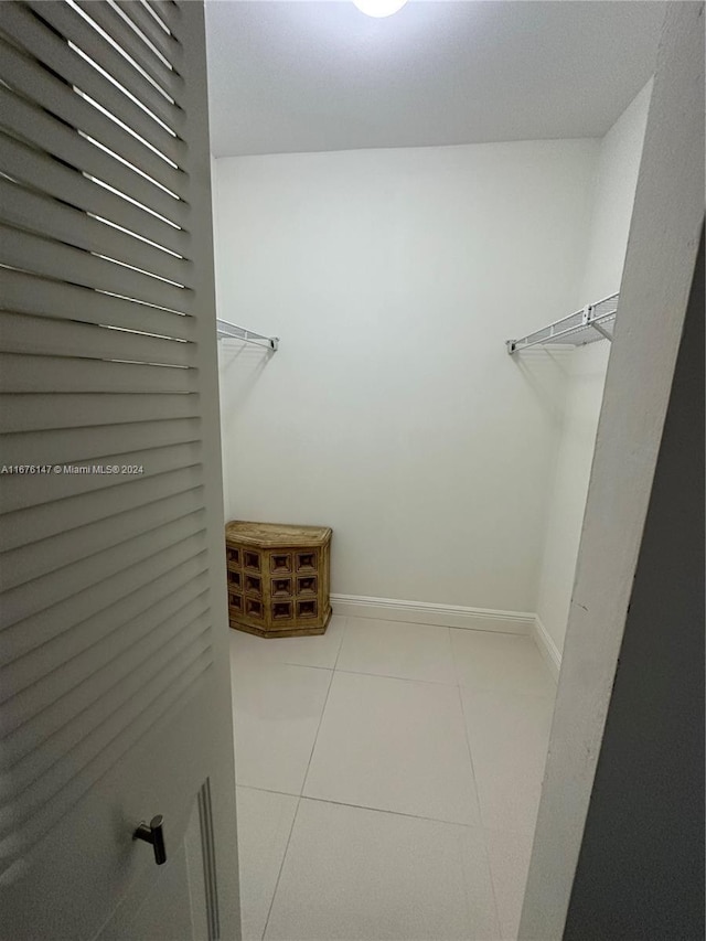 spacious closet featuring light tile patterned flooring