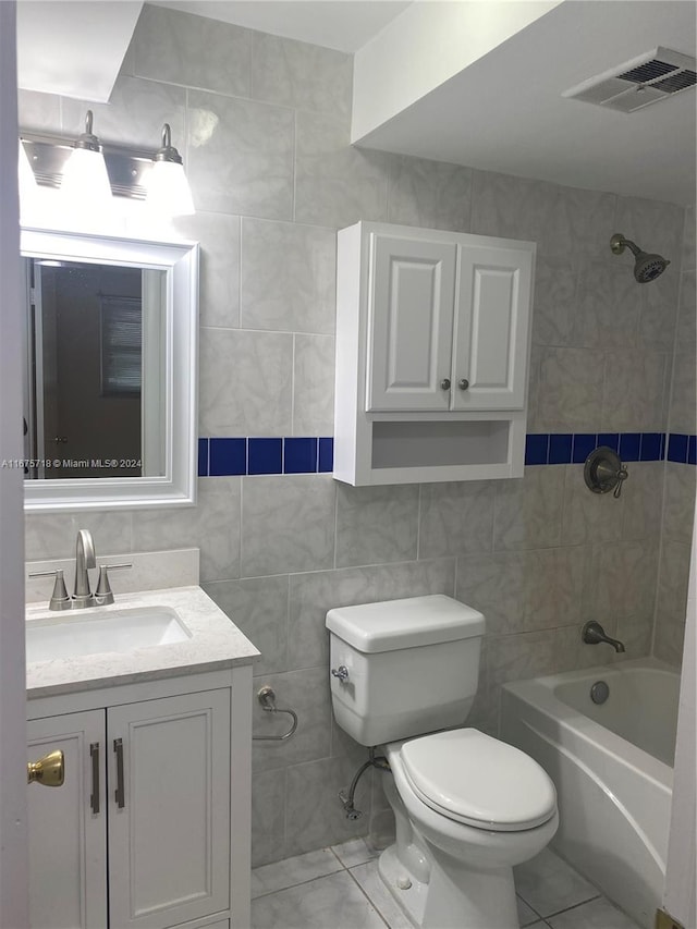 full bathroom featuring  shower combination, vanity, tile walls, and toilet