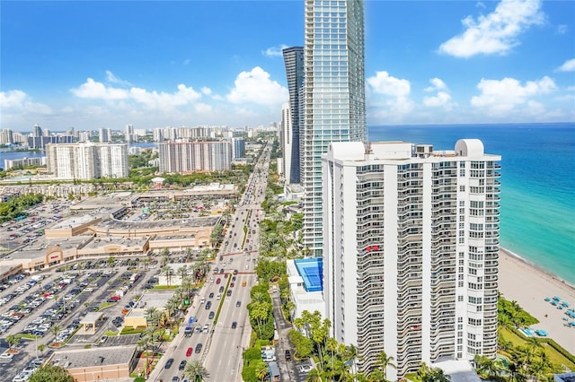 birds eye view of property featuring a water view and a view of the beach