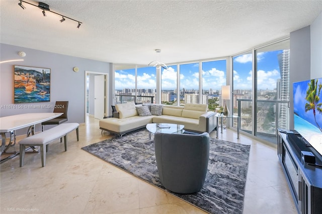 living room with floor to ceiling windows and a textured ceiling