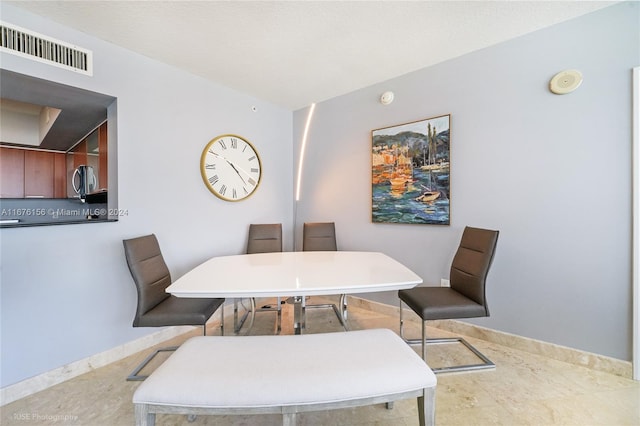 dining area featuring a textured ceiling