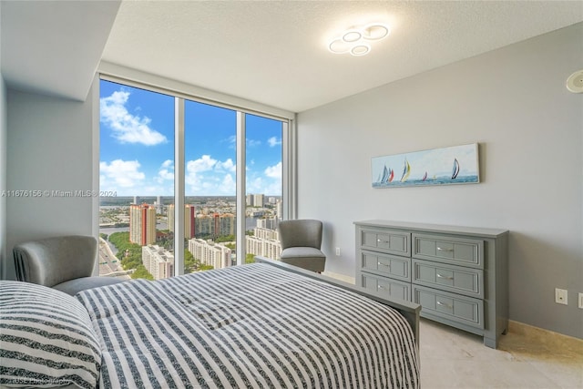 bedroom with expansive windows and a textured ceiling