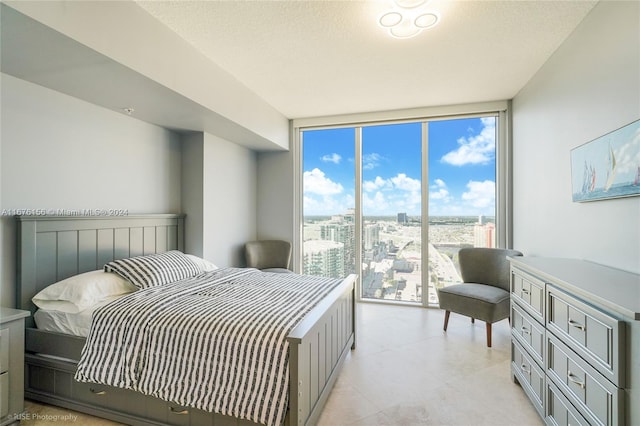 bedroom with expansive windows and a textured ceiling