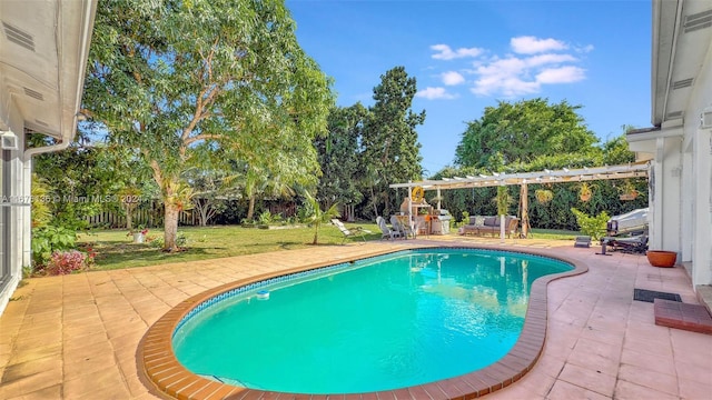 view of pool with a yard and a patio