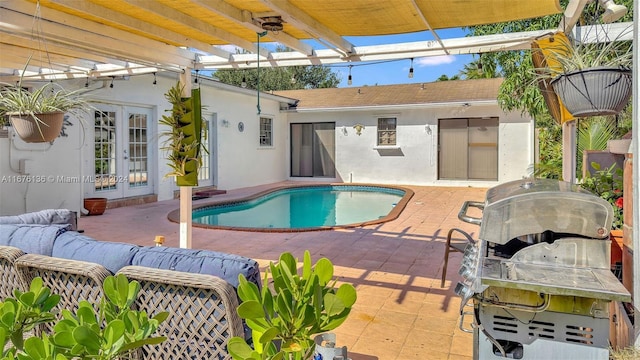 view of swimming pool featuring grilling area, french doors, an outdoor hangout area, a pergola, and a patio area