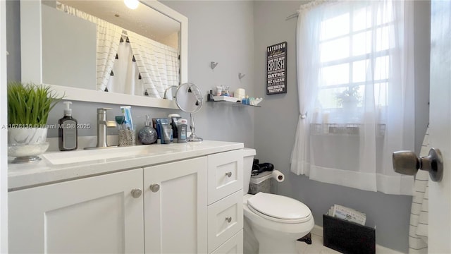 bathroom featuring vanity and toilet