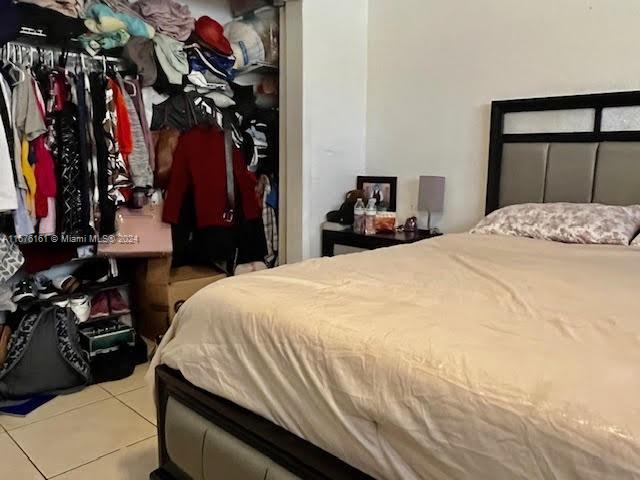 bedroom with light tile patterned flooring