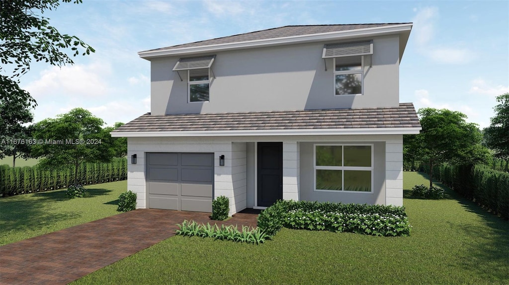 view of front of home featuring a garage and a front yard