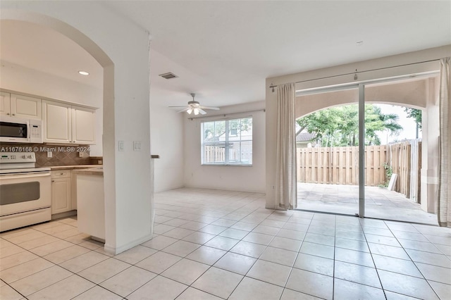 kitchen with white appliances, ceiling fan, tasteful backsplash, and light tile patterned floors