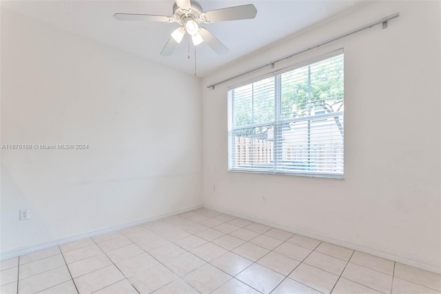 unfurnished room with ceiling fan and light tile patterned floors