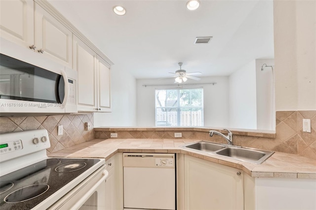 kitchen featuring decorative backsplash, sink, white cabinets, white appliances, and ceiling fan