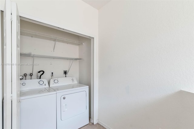 clothes washing area with washing machine and dryer