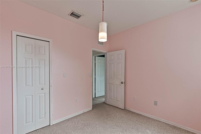 unfurnished bedroom with carpet flooring and a closet