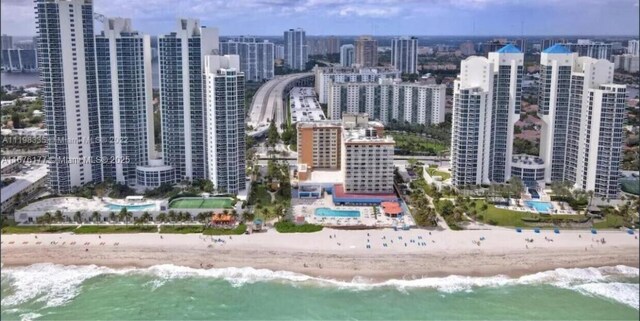 bird's eye view featuring a view of the beach and a water view