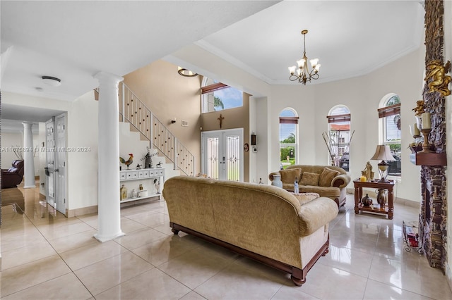 living room featuring crown molding, a chandelier, and light tile patterned floors