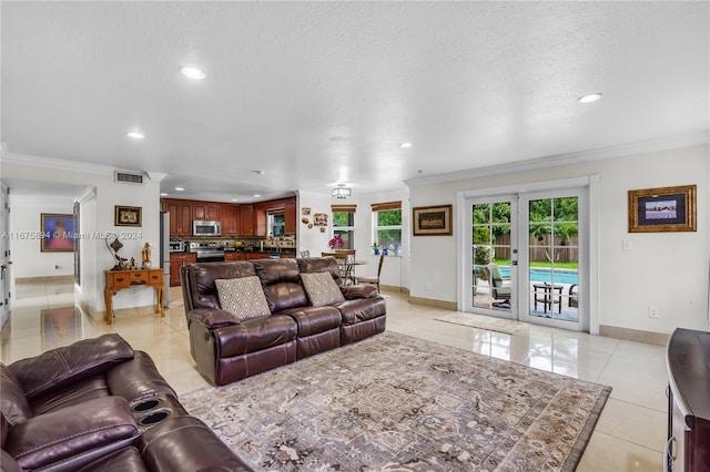 living room with light tile patterned flooring, french doors, ornamental molding, and a textured ceiling