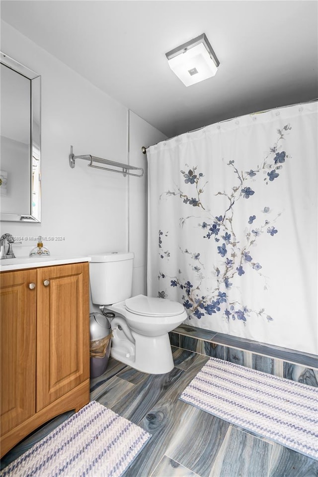 bathroom with vanity, toilet, and a shower with shower curtain