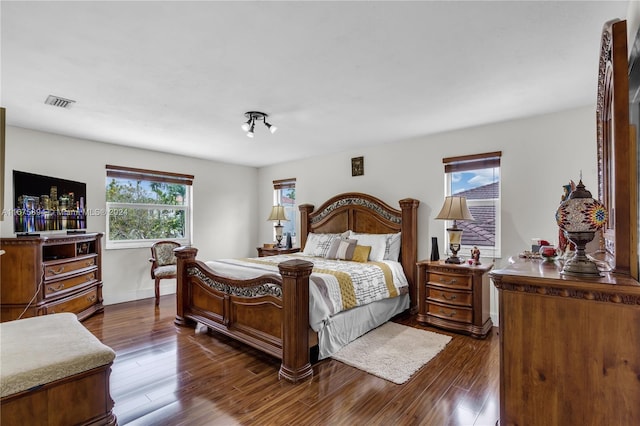 bedroom with dark wood-type flooring