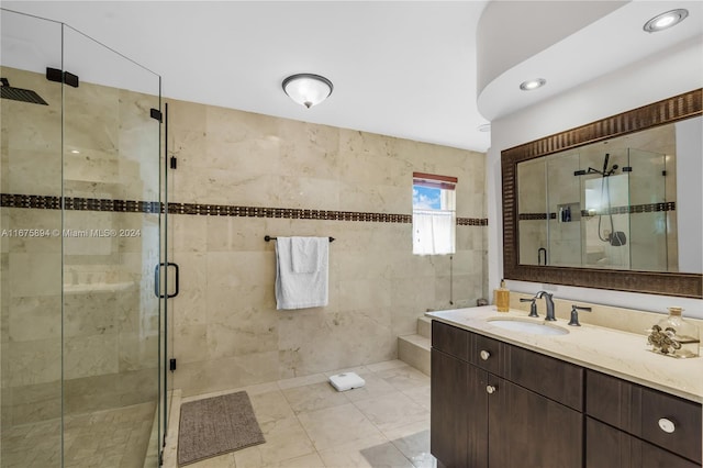 bathroom with tile patterned flooring, vanity, and a shower with shower door