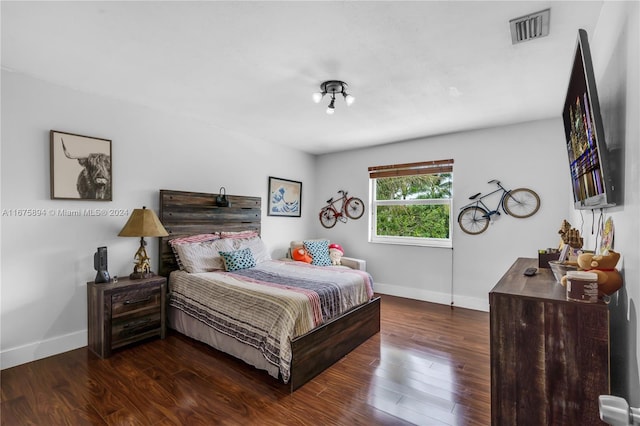 bedroom featuring dark hardwood / wood-style flooring