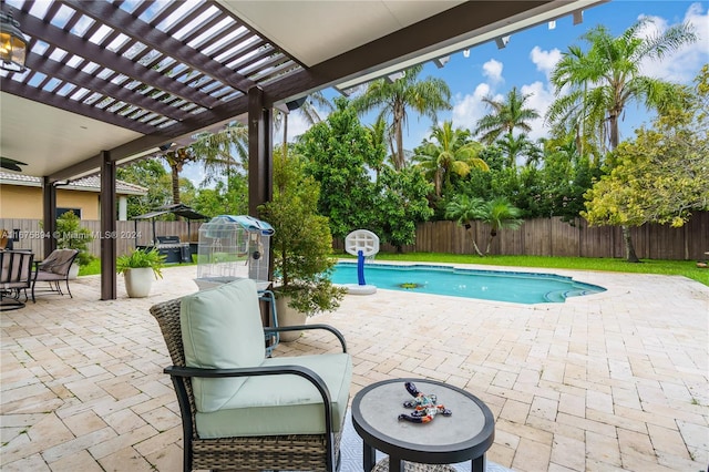 view of swimming pool with a patio and a pergola