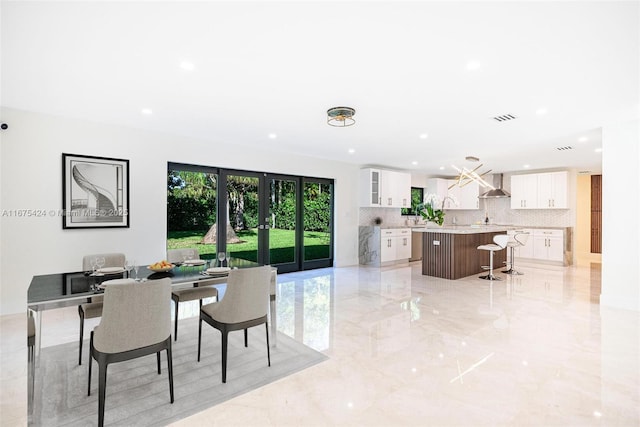 dining space with marble finish floor, french doors, visible vents, and recessed lighting