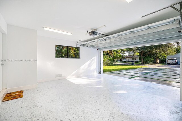 garage featuring visible vents and a garage door opener