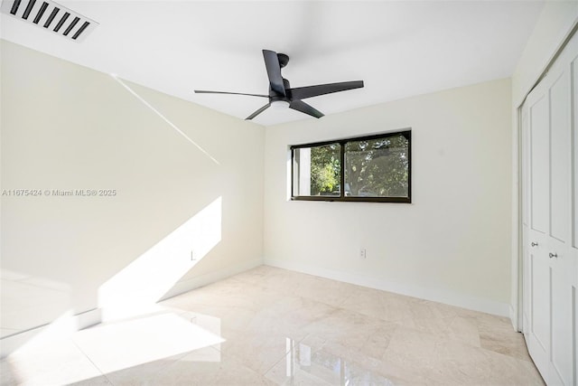 unfurnished bedroom with a closet, visible vents, ceiling fan, and baseboards