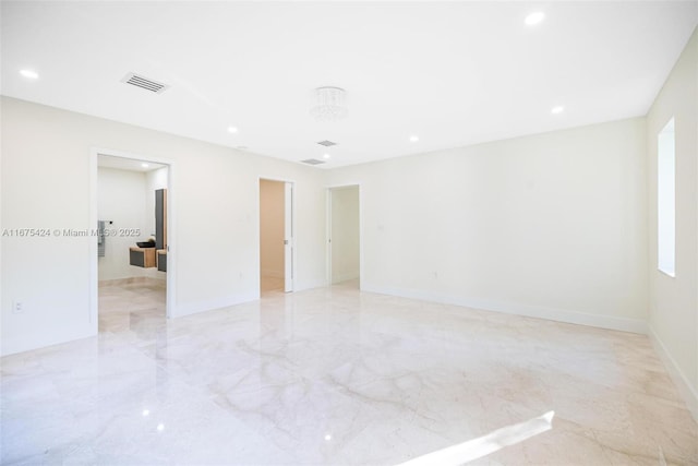 empty room with recessed lighting, marble finish floor, visible vents, and baseboards