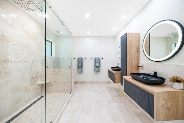 full bathroom with two vanities, tile patterned flooring, walk in shower, a sink, and recessed lighting