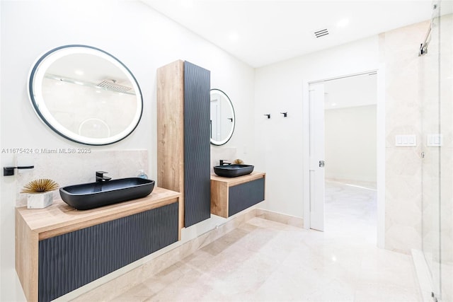 full bath featuring visible vents, two vanities, a sink, and recessed lighting