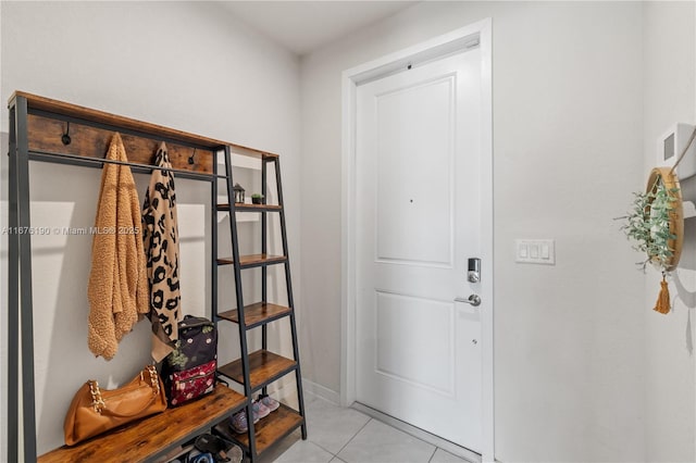 mudroom featuring baseboards and light tile patterned flooring