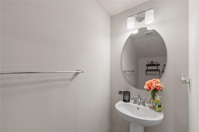 bathroom with visible vents and a sink