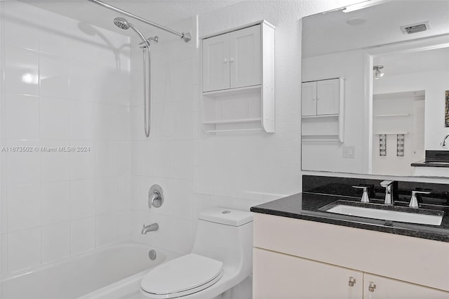 full bathroom featuring toilet, tiled shower / bath combo, and vanity