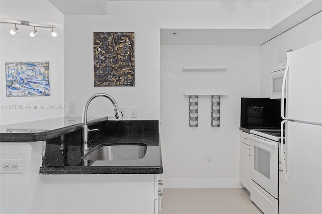 kitchen featuring white cabinets, white appliances, light tile patterned floors, and sink