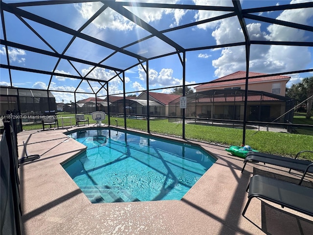 view of pool featuring a yard, glass enclosure, and a patio area