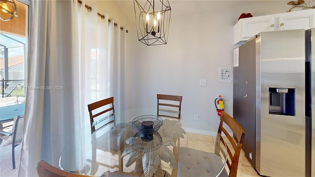 tiled dining space featuring a chandelier