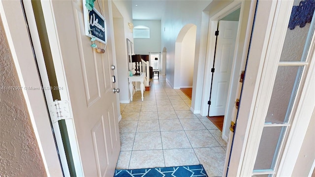 hall with light tile patterned floors