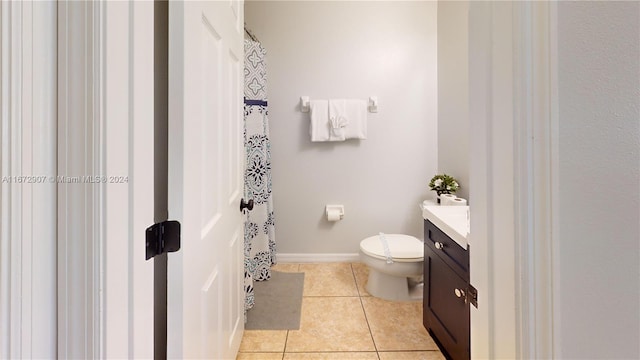 bathroom with tile patterned flooring, vanity, and toilet