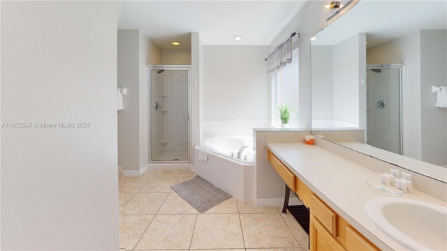 bathroom featuring vanity, shower with separate bathtub, and tile patterned flooring