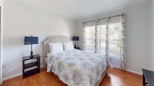 bedroom with hardwood / wood-style flooring