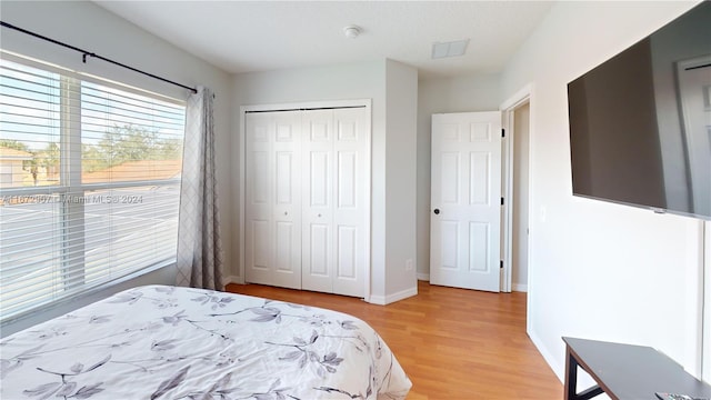 bedroom featuring hardwood / wood-style flooring and a closet