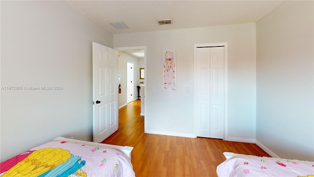 bedroom featuring a closet and light hardwood / wood-style flooring