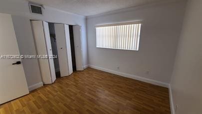 unfurnished bedroom with wood-type flooring