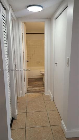 hall featuring light tile patterned flooring