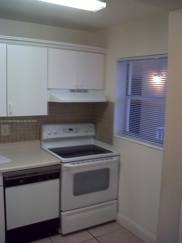 kitchen with light tile patterned flooring, white appliances, ventilation hood, backsplash, and white cabinets