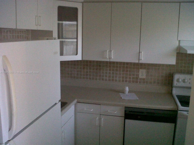 kitchen with white cabinets, tasteful backsplash, and white appliances