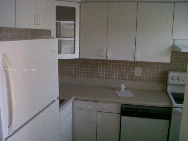 kitchen with decorative backsplash, white appliances, extractor fan, light countertops, and white cabinetry
